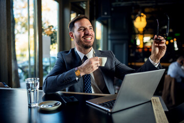 Young adult handsome attractive stylish businessman take a break and drink coffee