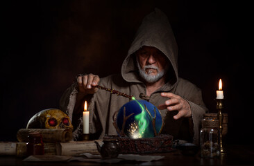 Medieval wizard cast magic with magic wand and crystal ball