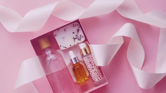 Beauty box subscription package with skincare, spa and makeup cosmetic products on pink background, flatlay design, natural cosmetics gift delivery
