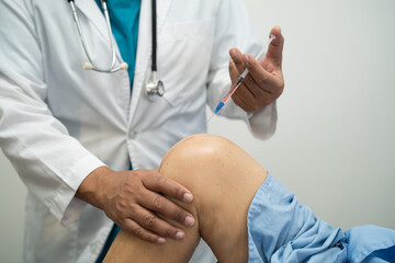 Asian doctor inject Hyaluronic acid platelet rich plasma into the knee of senior woman to walk...