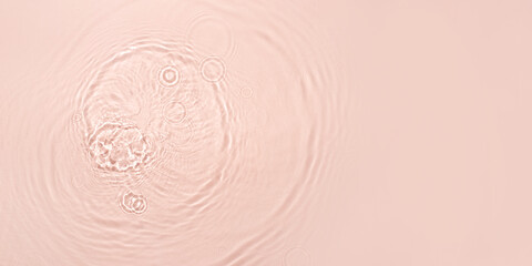 The texture of water on a pink background.
