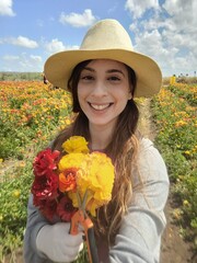 Happy Woman in a Field of Flowers on a Bright Day