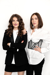Portrait of serious emotional female leaders looking at the camera in stylish suits. Beautiful business women posing with crossed arms, attractive and gorgeous lady boss of confidence and success
