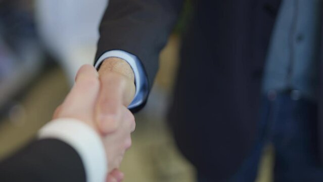 POV shot personal perspective shot of a businesswoman shaking hands with a businessman in the office.