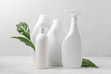 Set of white bottles with cleaning products on white background. Cleaning service concept