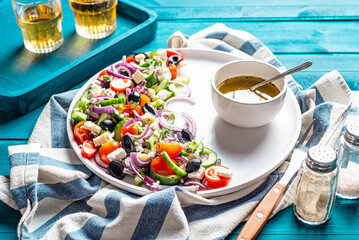 Fresh summer salad with cucumber, black olives, tomatoes, feta, red onion.