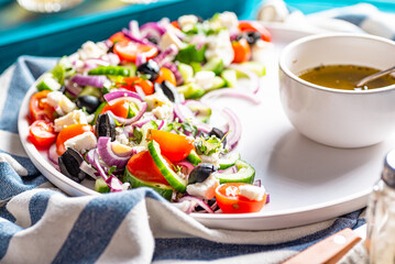 Fresh summer salad with cucumber, black olives, tomatoes, feta, red onion.