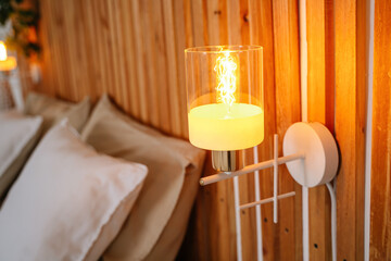 White wall sconces with yellow bulb on. High quality photo