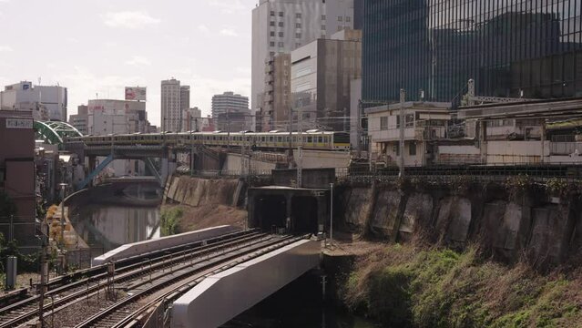 Sunrise over Tokyo. Train arrives at Ochanomizu Station over Kanda River