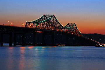 The sun sets on the old Tappan Zee Bridge and the Hudson River.  The bridge was removed and replaced in 2017