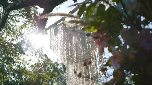 macrame in the sun. Environmentally friendly modern concept of knitted DIY natural decor.wicker decoration
