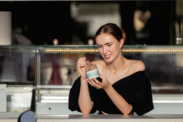 Portrait of young happy woman eating ice-cream, outdoor