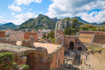 Fototapeta na wymiar Ancient theatre in Taormina, Sicily. Beautiful pamoramic view in sunny summer day. 