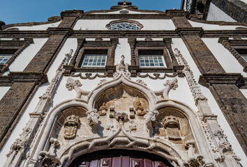 Fototapeta na wymiar Manueline details, windows, rose window and cross on the facade of the São Sebastião Church in Ponta Delgada, São Miguel - Azores PORTUGAL