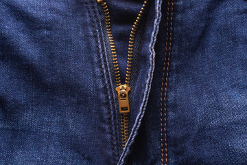 Unzipped jeans. Golden brass zipper on blue jeans. © Yevhenii
