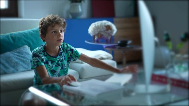 Young boy using computer desktop browsing internet