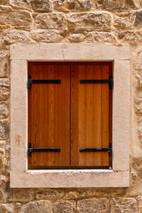 Shuttered window in an old stone house. Close-up