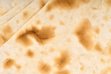 pitta bread. Close-Up Of Pita Bread Over White Background. Flatbreads on wooden table. Piadina, italian tortilla.