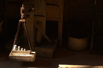 Vintage wooden old  weight on brown background, weighing scale.