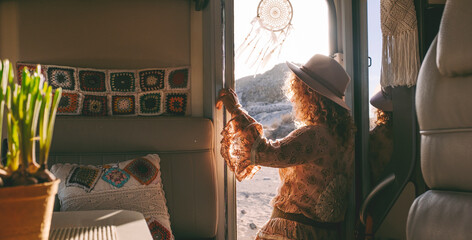 Travel lifestyle people. Female viewed from inside a camper van with handmade decoration. Traveler...