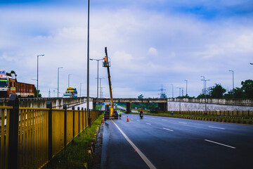 bridge over the road and men working on a crane.