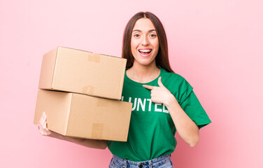 hispanic pretty woman feeling happy and pointing to self with an excited. volunteer concept