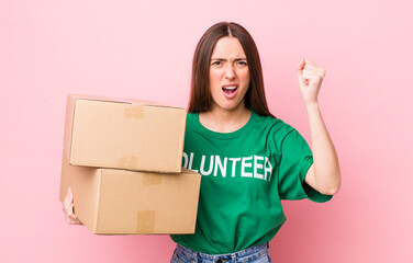 hispanic pretty woman shouting aggressively with an angry expression. volunteer concept