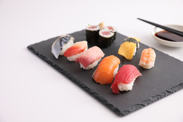 Sushi Set nigiri and sushi rolls with soy sauce and chopsticks Japanese food isolated in white background