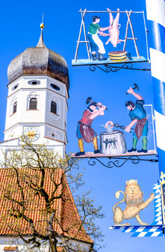 Andechs, Germany - April 14: typical bavarian maypole with old paintings in front of blue sky in Andechs on April 14, 2022