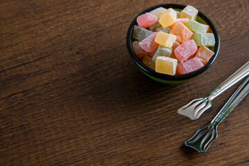 Traditional Turkish delight in a bowl on a wooden background	