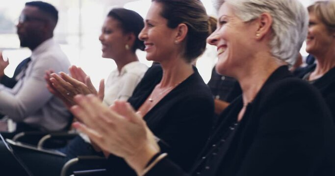 We always appreciate a good conference. 4k footage of a group of businesspeople clapping hands while sitting in a conference.