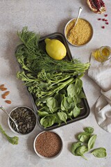 Plant based raw food vegan  bulgur pumpkin seeds flax seeds  fresh broccoli spinach. Nutrient rich balanced food concept. 