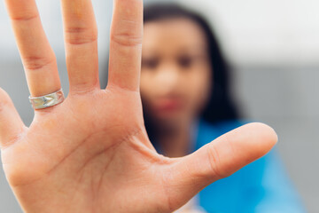 Close-up of a woman's palm, makes the hand stop the denial gesture, expresses prohibition,...