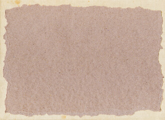 Fototapeta premium Craft paper with torn edges on natural background of canvas
