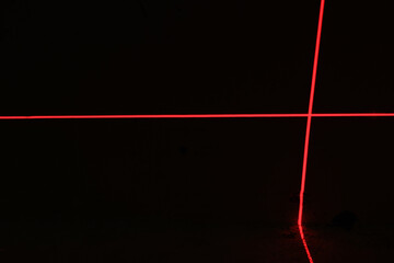 Red laser beams on black background