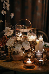 Fototapeta na wymiar Wedding decor at the restaurant. Beautiful table setting with autumn flowers, orange and burning candles.