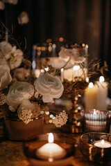 Wedding decor at the restaurant. Beautiful table setting with autumn flowers, orange and burning candles.