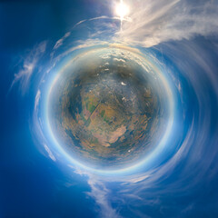 Aerial view from airplane window at high altitude of little planet earth covered with white thin...