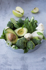 Green vegetables and fresh fruits containing vitamin K. Foods rich in vitamin K, minerals and dietary fiber. Healthy nutrition concept.