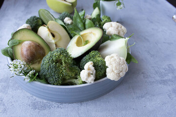 Green vegetables and fresh fruits containing vitamin K. Foods rich in vitamin K, minerals and dietary fiber. Healthy nutrition concept.