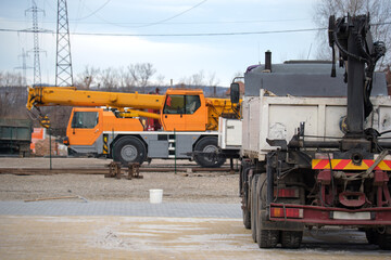 Heavy duty truck and mobile lifting crane at construction site