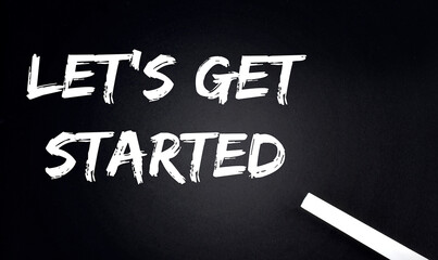 LET'S GET STARTED Text on Black Chalkboard with a piece of chalk
