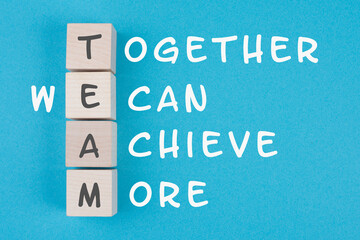 Team, together we can achieve more is standing on wooden cubes, business concept, teamwork strategy