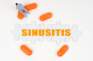 On the white surface of the tablet, a miniature human figure and puzzles with the inscription - SINUSITIS