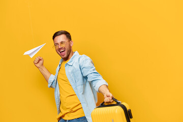 Overjoyed cheerful tanned handsome man in blue shirt wait impatiently for vacation hold suitcase...