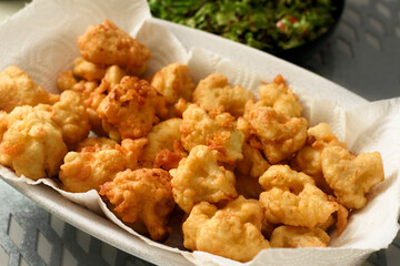 fried cauliflower dish in large white plate