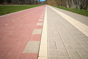 Pedestrian and bike paths converge on the horizon. Perspective. A special relief strip on the...