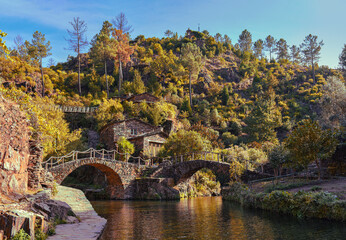 Old stone bridge over the river in beautiful historic village Piodao in Portugal, travel destination