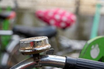 old rusty metal bell on pink saddle background, bokeh