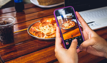 mano de persona influencer con celular tomando foto para historias de plato con comida en...